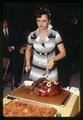 Woman cutting roast beef at Farm Bureau dinner, Corvallis, Oregon, circa 1970