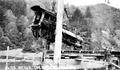 Locomotive being lifted on cables on a wooden tripod