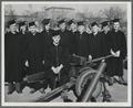 OSC student members of the Army Specialized Training Program posing with a field gun on graduation day
