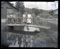 People on bridge next to house