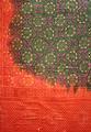 Sari of dark green and red cotton tie-dyed with geometric floral designs in white dots hand painted in golden yellow and magenta accents