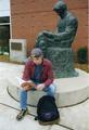 Student sitting near Library sculpture