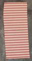 Textile Panel (towel?) of white woven cotton with red figured stripes of interlocking red squares framed by lines of small red dashes