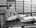 Man reviewing deed record books