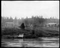 Two buildings on campus of St. Mary's Academy (Marylhurst) on bluff above Willamette River. Power plant between buildings. Small building along river in foreground.