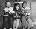 Three children with magazine