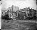 Building being torn down on site of Broadway Building, N. W. Broadway and Morrison, Portland. Theatre posters on building shell, Hotel Calumet in background.