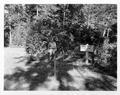 Man with sign -"Canal Creek Camp Spot Siuslaw National Forest"