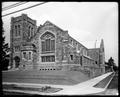 Westminster Presbyterian Church, 16th and Schuyler St., Portland. Stone building with tower, large stained glass window in foreground. Power lines overhead.