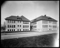 Hawthorne School on Alder St., Portland. Wood building with street and grass in foreground.