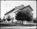 Gymnasium building at Washington High School, Portland. Foreground tree obscures entrance.