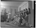 Barbara Keasey, of Alpha Delta Pi, checks her chorus in a rehearsal of Christmas carols, December 1950