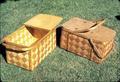 Two picnic baskets, one shellacked, one unshellacked. Both made 1973. 20.5 x 12.5 x 9.75 inches