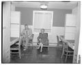 Unidentified individuals posing in the new men's residence co-op, September 1954