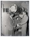 Bob Walls and Ted Mesang examining band uniforms