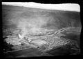 La Grande, Oregon.  Mill in forground with smoke rising from teepee burner.