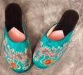 Slippers of turquoise blue silk with embroidered dragon and bright red fireball