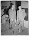 Jesse Harmond, USDA Flax Specialist, and Harry Dorman, State Budget Director, inspect fabric on a chair, October 23, 1950