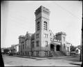 Sunnyside Methodist Episcopal Church at 35th and E. Yamhill, Portland. Stone building with tower. Houses in background.