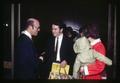 Family shaking hands with man in robe, Corvallis, Oregon, circa 1970