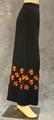 Palazzo pants of black polyester crepe with embroidered flowers encircling mid-calf