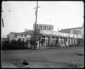 Portland Seed Co, Front and Yamhill. Low building with toole and trees on sidewalk.