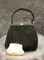 Handbag of black satin with jeweled gold snap closure at top