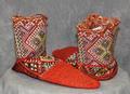Slipper booties of red-orange, black, white, green and purple geometrically patterned wool with accents of metallic threads