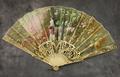 Folding fan of carved and painted ivory sticks mounted with elaborately painted white sheer silk
