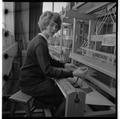 Home Economics student at a loom in the clothing and textiles research lab, February 1964