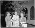 Women posing near a large plant in the Memorial Union at a president's summer session reception