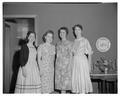 Four women posing at a tea party, circa 1955