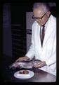 Joe Wales with trout and cancerous tumor, Oregon State University, Corvallis, Oregon, circa 1971