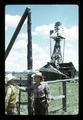 Dean Frischknecht interviewing Reub Long by a windmill at Harrison Ranch, near Fort Rock, Oregon, circa 1972