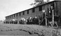 CCC members lined up to go inside barracks