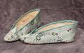 Slippers for bound feet of light aqua silk brocade with dainty floral design in green and pink with touches of red, blue, and purple