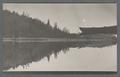 Row boat moored in a lake or placid river, circa 1910