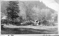 Buildings and cleared land and piled logs