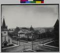 View from above intersection, 11th and Willamette, Eugene, OR., showing First Christian Church, Catholic Church, and First Methodist Episcopal Church. Public Library on foreground corner. House in background. (recto)