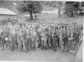 Group shot of older CCC members in hats in camp