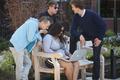 Group of students surrounding laptop at Global Scholars Hall.