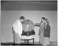 An unidentified faculty member and students examine an oversize globe used to promote International Week at OSC