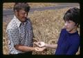 Polat Solen of Turkey and Margie Stiger holding different colored wheat kernels, North Willamette Experiment Station, Oregon State University, Aurora, Oregon, July 1972
