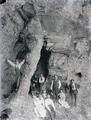 Group of people at entrance to a cave