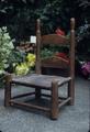 Small rawhide chair, seat is tanned not woven, once a rocker then rocker cut off, top finials are worn because the kids in the family learned to walk by turning the chair upside down and pushing it, 20 x 10 x 10 inches, 1870