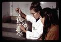 Unidentified researcher and "Melody" with oysters, Marine Science Laboratory, Oregon State University, Corvallis, Oregon, circa May 23, 1969