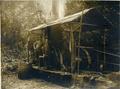 Two loggers with steam powered donkey engine