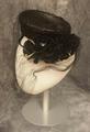 Pillbox of black straw with drop circlet embellished at sides with ruffles of black straw