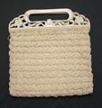 Handbag of off-white crochet in a fan stitch with a handle of carved ivory celluloid in an open floral design