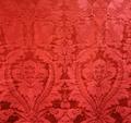 Drapery yardage of red silk satin damask in a large design of fruit and foliage